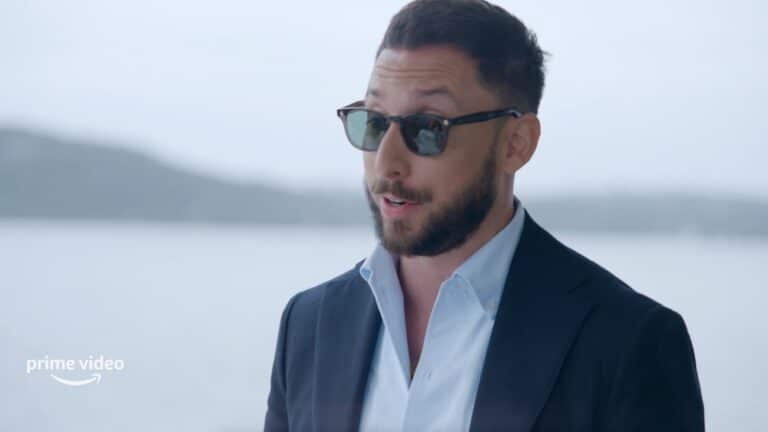 A guy in shades wearaing a black suit